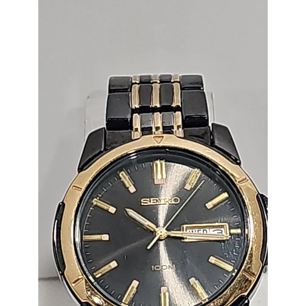 Seiko Quartz 100M watch (black and gold two-tone with day/date)